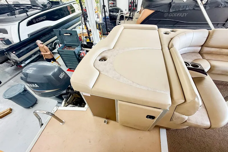 Slide: The Image of 2011 Bennington 2275RLi pontoon boat interior with Yamaha 150 engine in a workshop setting. - 8