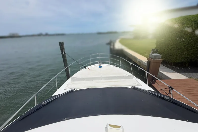 Slide: The Image of Azimut Fly 50 yacht docked by the water, 2022 model, with sunlit surroundings. - 1