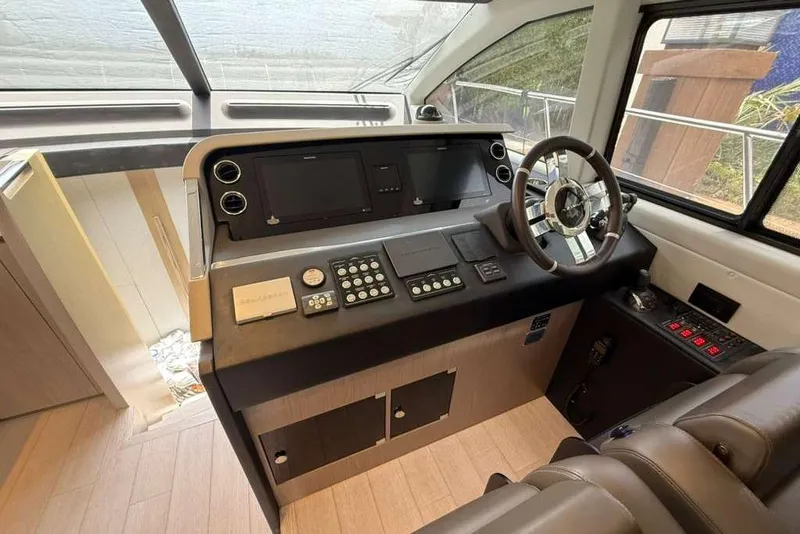 Slide: The Image of Cockpit of 2022 Azimut Fly 50 yacht with modern controls and steering wheel. - 11
