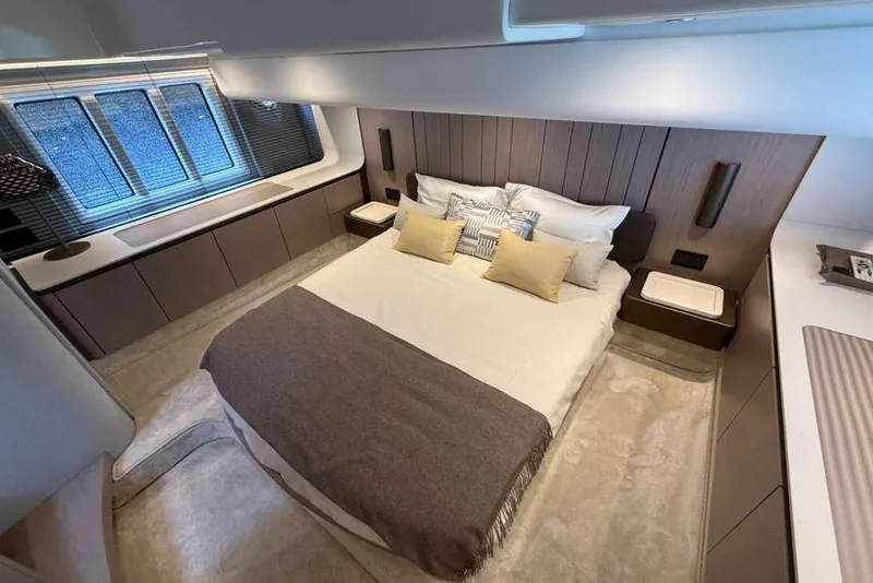 Slide: The Image of Luxurious bedroom interior of 2022 Azimut Fly 50 yacht, featuring elegant design and cozy bedding. - 15