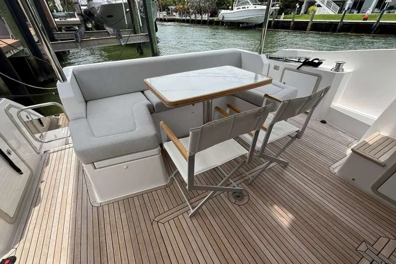 Slide: The Image of Luxurious 2022 Azimut Fly 50 yacht deck with elegant seating and table setup. - 2