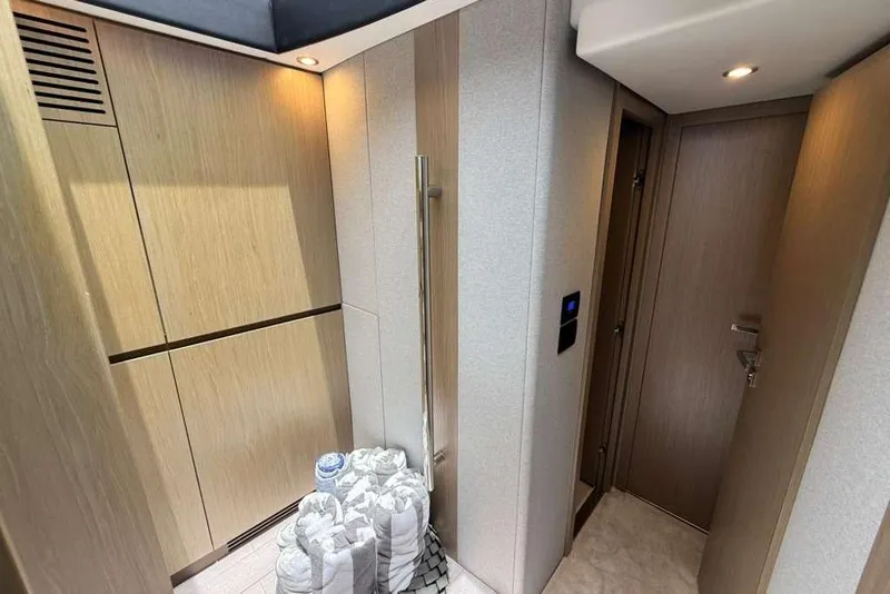 Slide: The Image of Interior of 2022 Azimut Fly 50 yacht, featuring modern wood paneling and ambient lighting. - 21