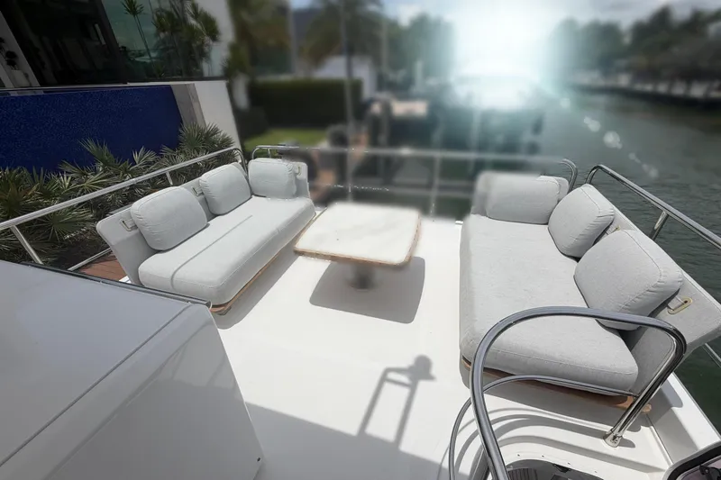 Slide: The Image of Luxurious seating area on 2022 Azimut Fly 50 yacht, featuring plush white sofas and a table. - 27