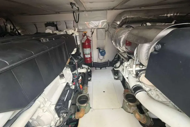 Slide: The Image of Engine room of 2022 Azimut Fly 50 yacht, featuring dual engines and fire extinguisher. - 36