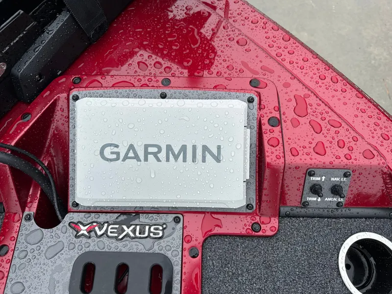 Slide: The Image of Vexus AVX1880 2025 with Garmin device and water droplets on red deck. - 20
