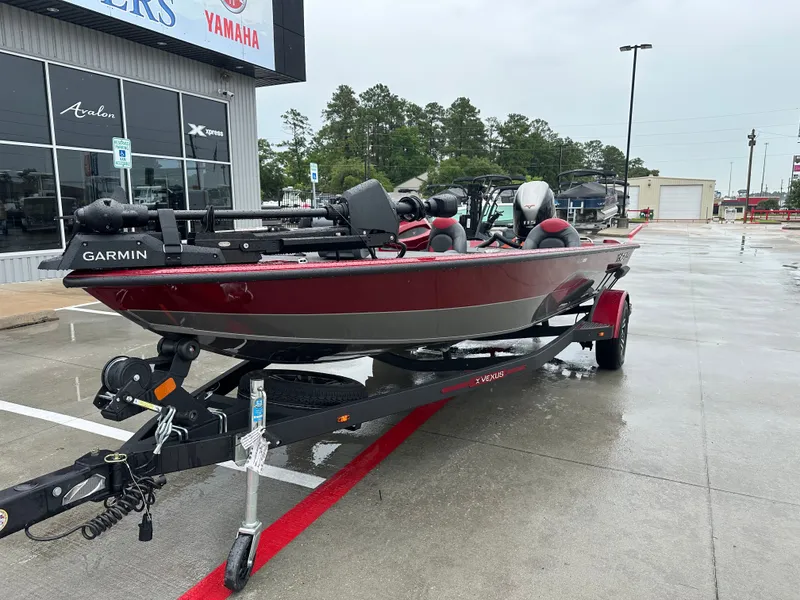 Slide: The Image of 2025 Vexus AVX1880 boat on trailer outside a store. - 3