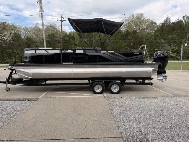 Slide: The Image of 2026 Avalon Venture 85 pontoon boat parked on trailer outdoors. - 13