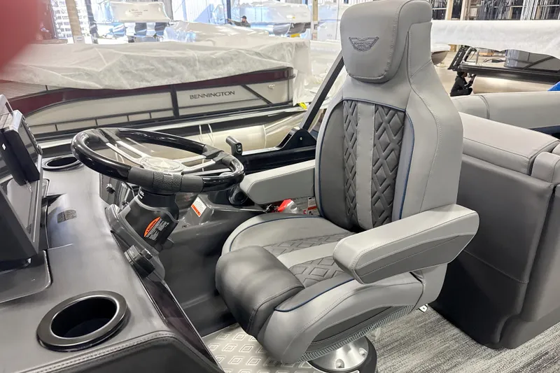 Slide: The Image of Captain's chair and steering wheel of 2026 Bennington 22 M Open Fastback Quad Bench boat. - 14