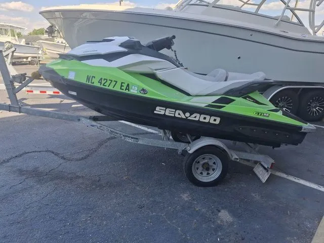The Image of 2014 Sea-Doo GTI jet ski on trailer, green and black. - 1