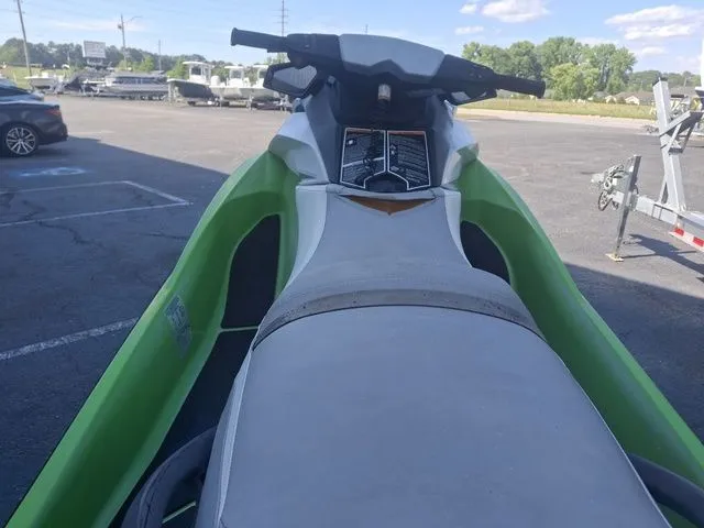 Slide: The Image of Green 2014 Sea-Doo GTI jet ski in parking lot. - 4
