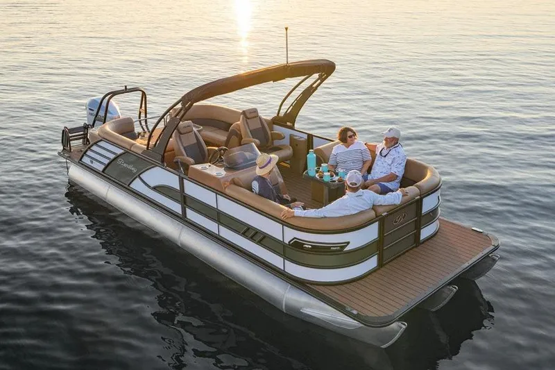 Slide: The Image of Manufacturer Provided Image: 2026 Bentley Pontoons Elite 223 Swingback on serene water at sunset with passengers. - 3