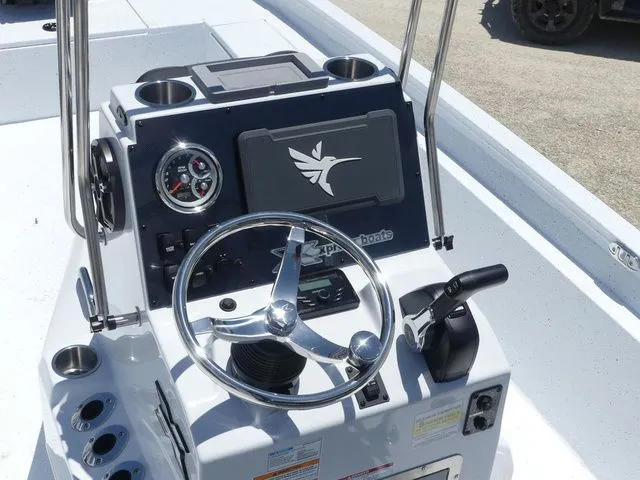 Slide: The Image of Xpress Boats SW22B 2026 steering console with wheel and gauges. - 13