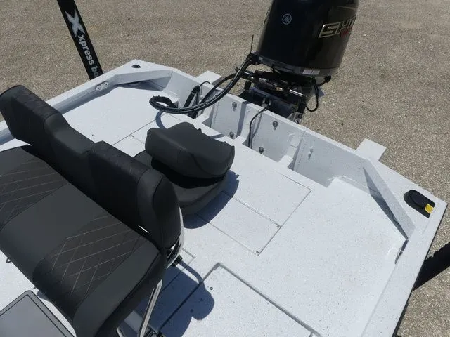Slide: The Image of 2026 Xpress Boats SW22B with motor and seating area. - 15