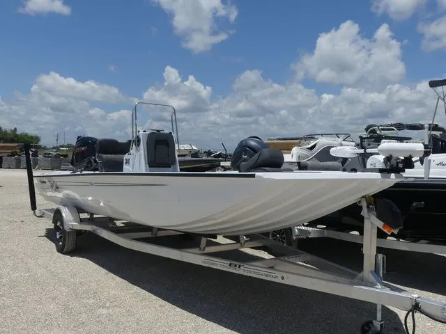 Slide: The Image of 2026 Xpress Boats SW22B on trailer under blue sky. - 3