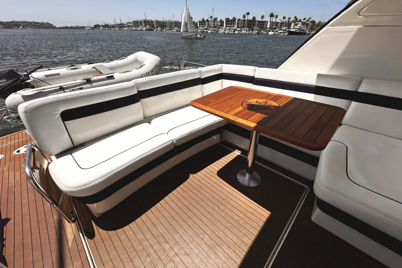 Slide: The Image of Luxurious seating area on 2010 Sea Ray 450 Sundancer yacht with wooden table, docked by marina. - 11