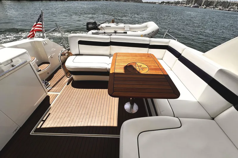 Slide: The Image of Luxurious 2010 Sea Ray 450 Sundancer yacht deck with elegant seating and wooden table. - 12