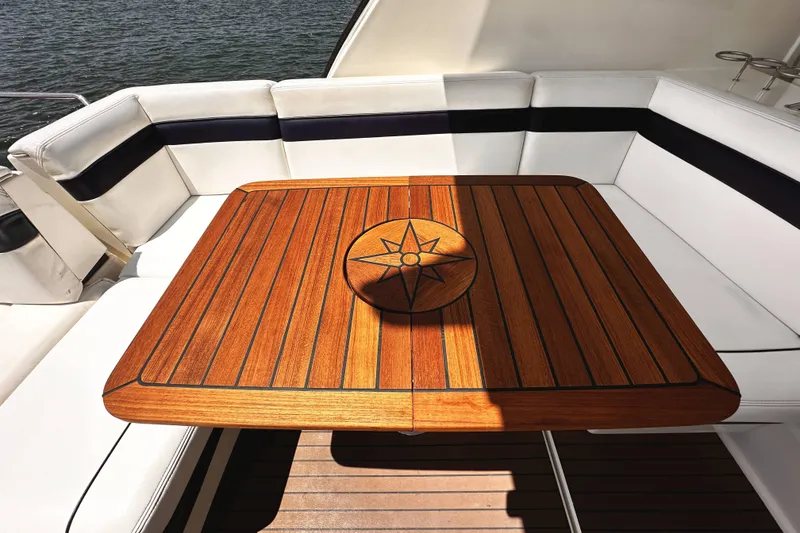 Slide: The Image of Luxurious seating area on a 2010 Sea Ray 450 Sundancer yacht with wooden table. - 14