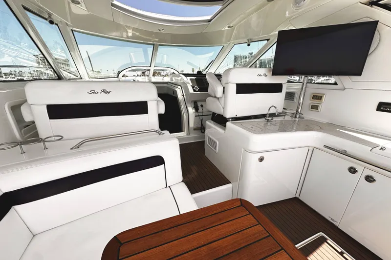 Slide: The Image of Luxurious interior of 2010 Sea Ray 450 Sundancer yacht with elegant seating and modern amenities. - 16