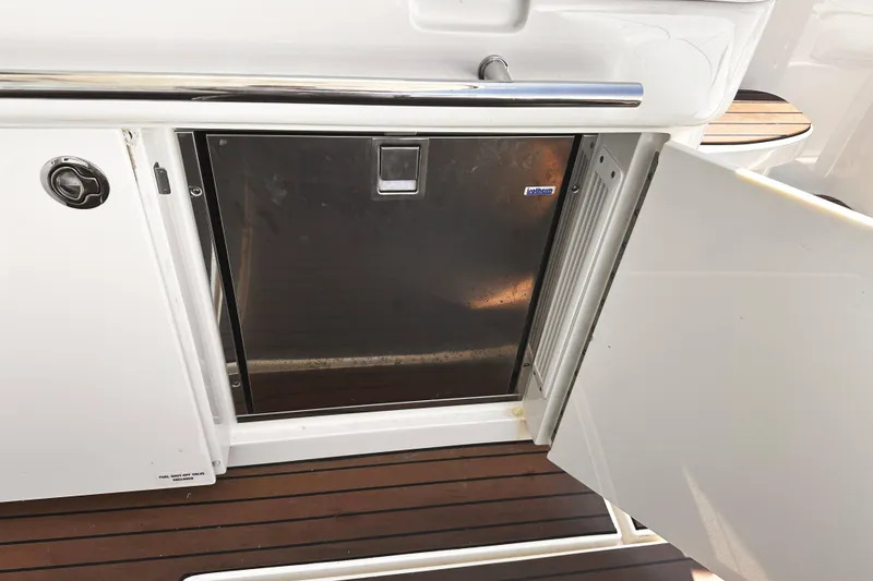 Slide: The Image of Open refrigerator on 2010 Sea Ray 450 Sundancer yacht, featuring sleek stainless steel design. - 18