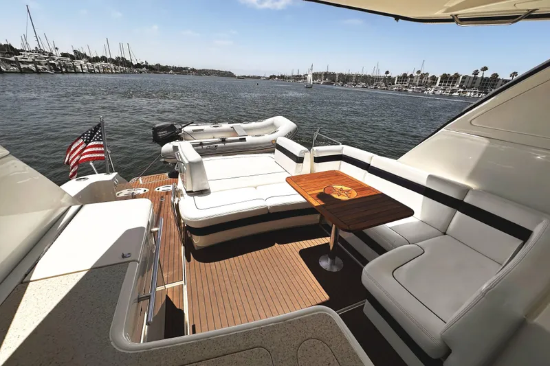 Slide: The Image of Luxurious 2010 Sea Ray 450 Sundancer yacht with elegant seating and scenic marina view. - 20