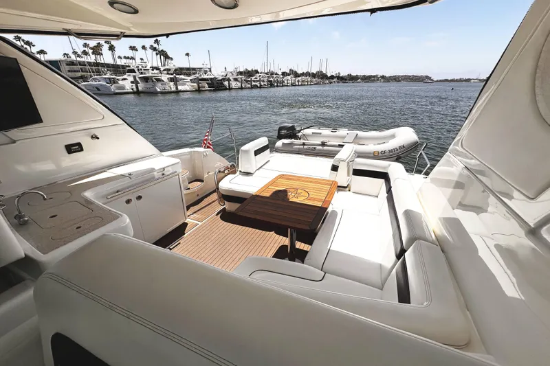 Slide: The Image of Luxurious 2010 Sea Ray 450 Sundancer yacht interior with seating and table, docked at marina. - 21