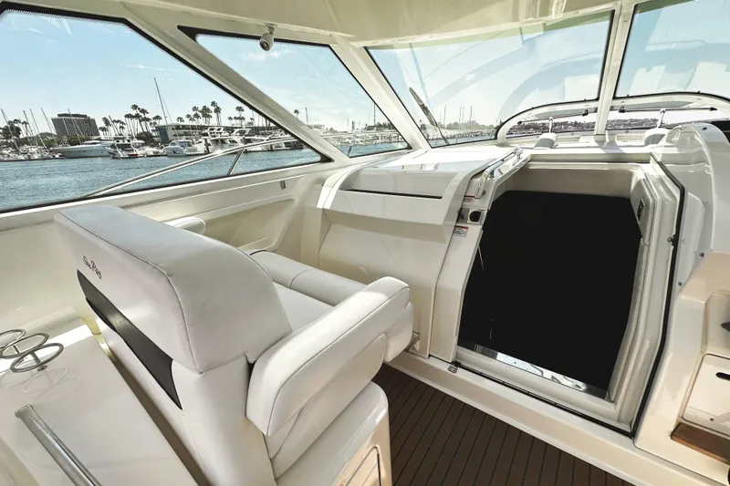 Slide: The Image of Interior view of 2010 Sea Ray 450 Sundancer yacht with helm and marina backdrop. - 22