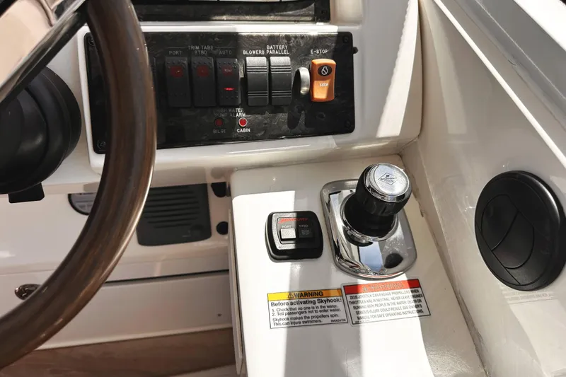Slide: The Image of Control panel of a 2010 Sea Ray 450 Sundancer boat, featuring switches and throttle controls. - 29