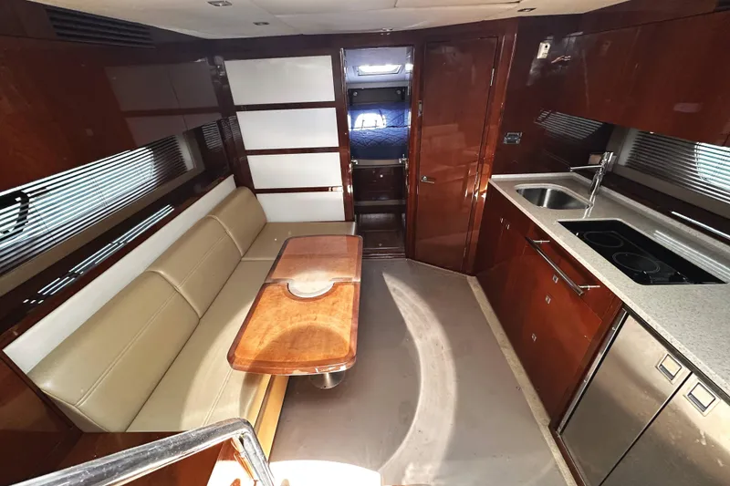 Slide: The Image of Luxurious interior of 2010 Sea Ray 450 Sundancer yacht with modern kitchen and seating area. - 32