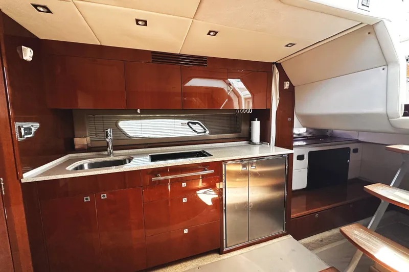 Slide: The Image of Luxurious 2010 Sea Ray 450 Sundancer yacht interior kitchen with modern amenities. - 33