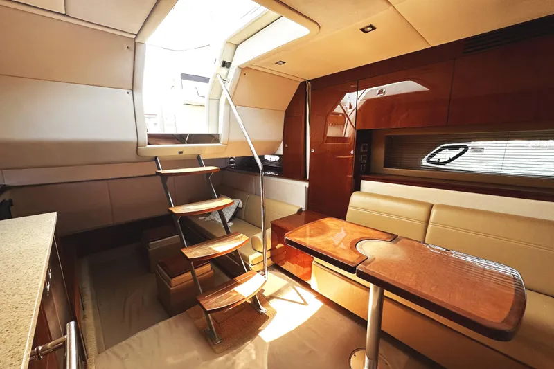 Slide: The Image of Interior of 2010 Sea Ray 450 Sundancer yacht with elegant seating and wooden table. - 35