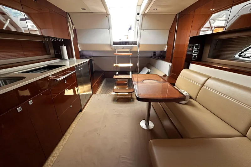 Slide: The Image of Luxurious interior of 2010 Sea Ray 450 Sundancer yacht with modern kitchen and seating area. - 38