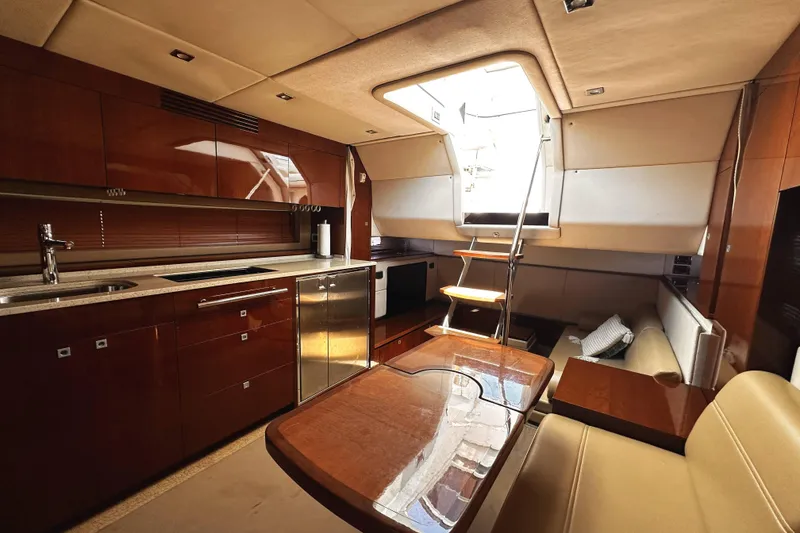 Slide: The Image of Luxurious interior of 2010 Sea Ray 450 Sundancer yacht with modern kitchen and seating area. - 39