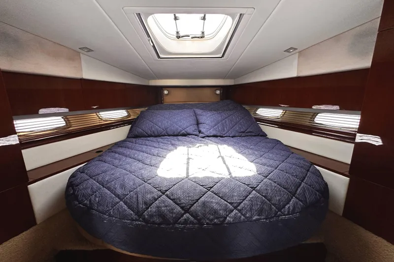 Slide: The Image of Luxurious cabin interior of 2010 Sea Ray 450 Sundancer yacht with skylight and cozy bedding. - 40