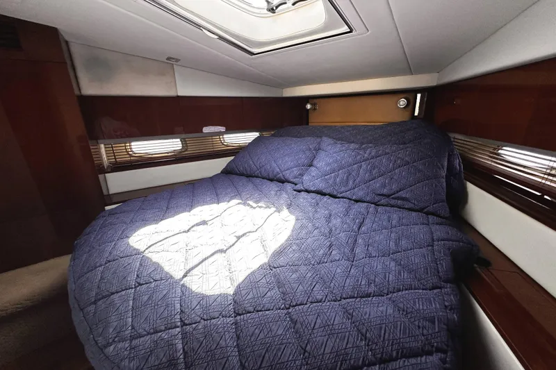 Slide: The Image of Luxurious cabin interior of 2010 Sea Ray 450 Sundancer with cozy bed and elegant wood finish. - 42