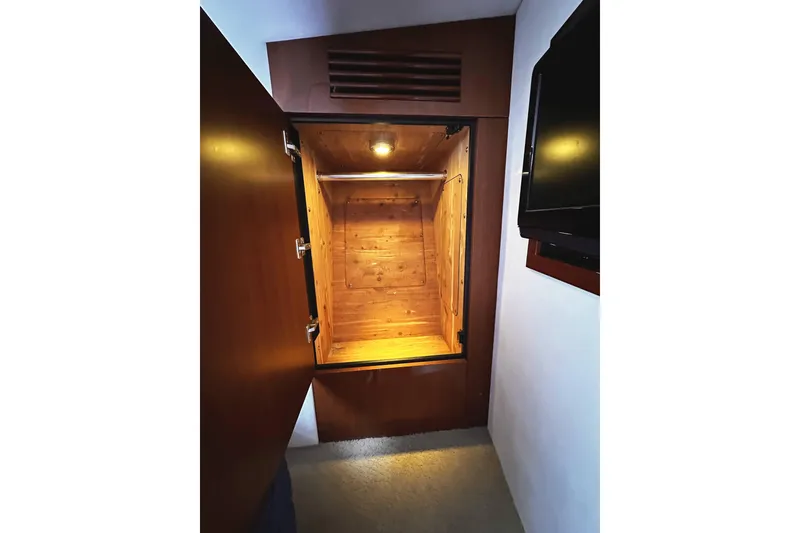 Slide: The Image of Interior view of a 2010 Sea Ray 450 Sundancer yacht's wooden storage compartment. - 43