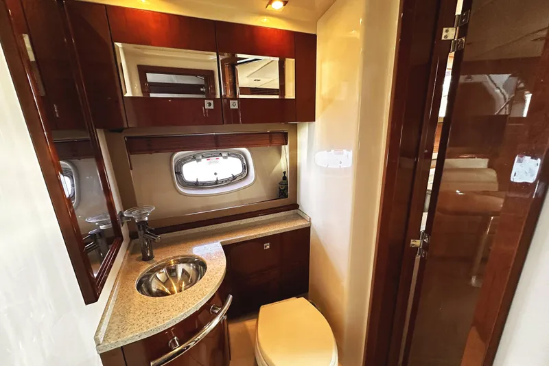 Slide: The Image of Luxurious bathroom in 2010 Sea Ray 450 Sundancer yacht with wood cabinetry and modern fixtures. - 45