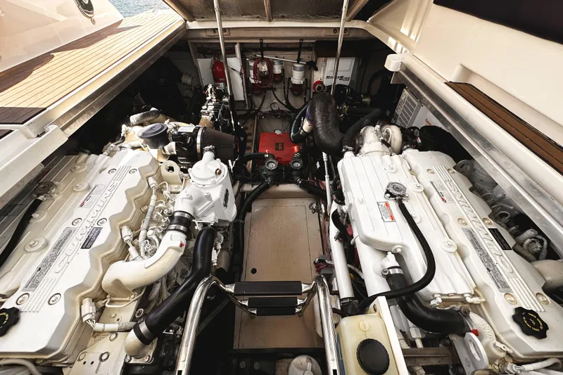 Slide: The Image of Engine room of a 2010 Sea Ray 450 Sundancer yacht, featuring dual Cummins engines. - 50