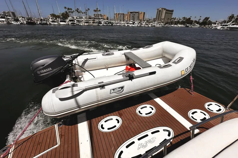 Slide: The Image of Inflatable dinghy with Yamaha motor on Sea Ray 450 Sundancer, 2010, docked in marina. - 54