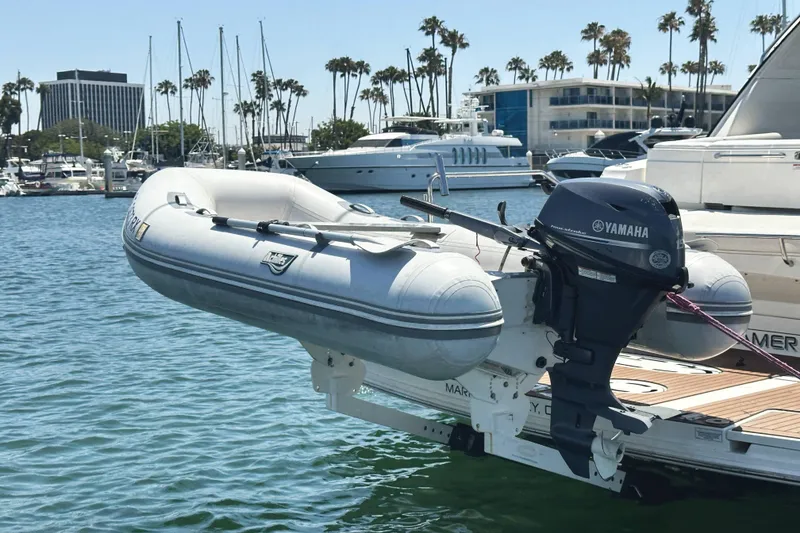 Slide: The Image of Inflatable dinghy with Yamaha motor on a 2010 Sea Ray 450 Sundancer yacht in marina. - 55