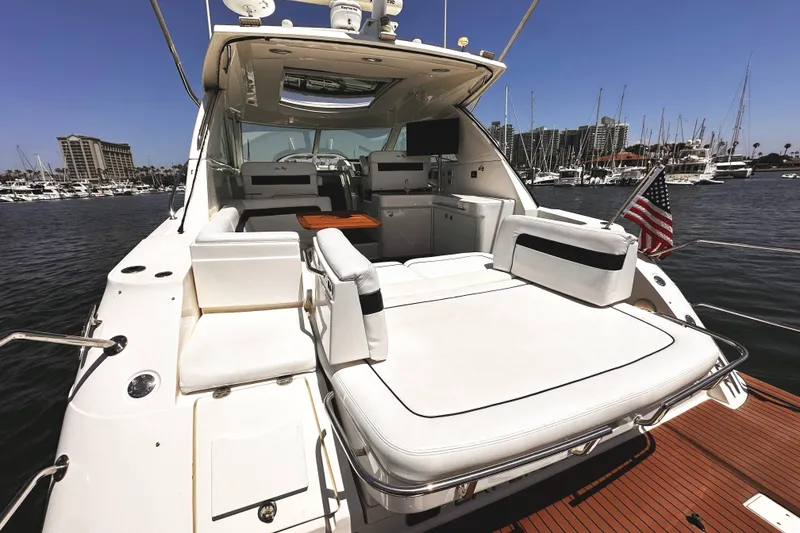 Slide: The Image of 2010 Sea Ray 450 Sundancer yacht with spacious deck and marina view. - 7