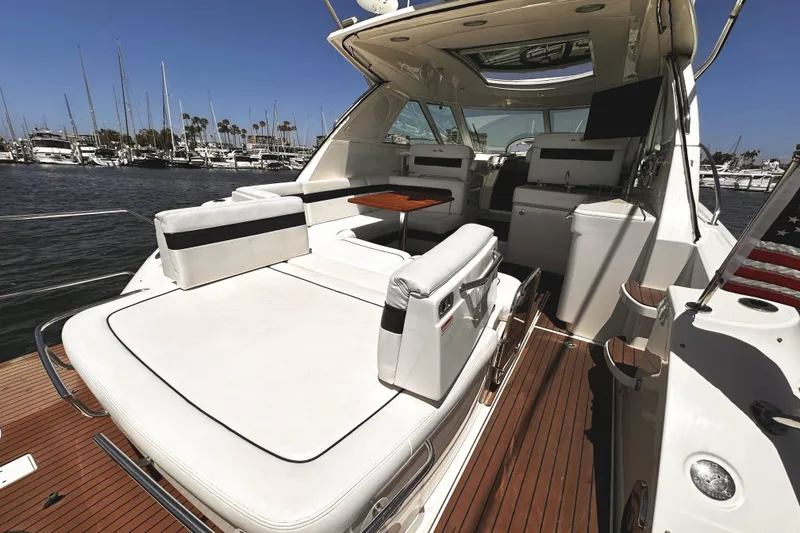 Slide: The Image of Luxurious 2010 Sea Ray 450 Sundancer yacht interior with elegant seating and wooden deck. - 9
