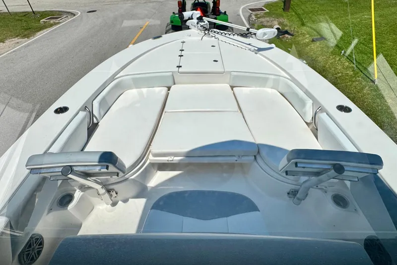 Slide: The Image of 2021 Robalo 246 Cayman boat interior with white seating and modern design. - 13