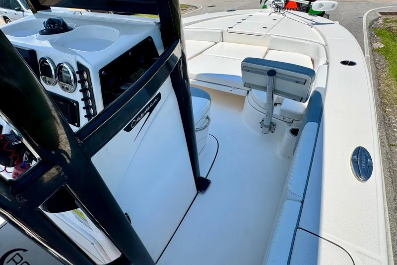 Slide: The Image of 2021 Robalo 246 Cayman boat interior with console and seating, showcasing modern design. - 14