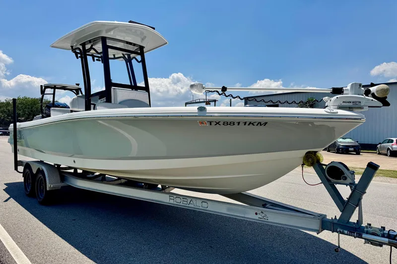 Slide: The Image of 2021 Robalo 246 Cayman boat on trailer under clear blue sky. - 5