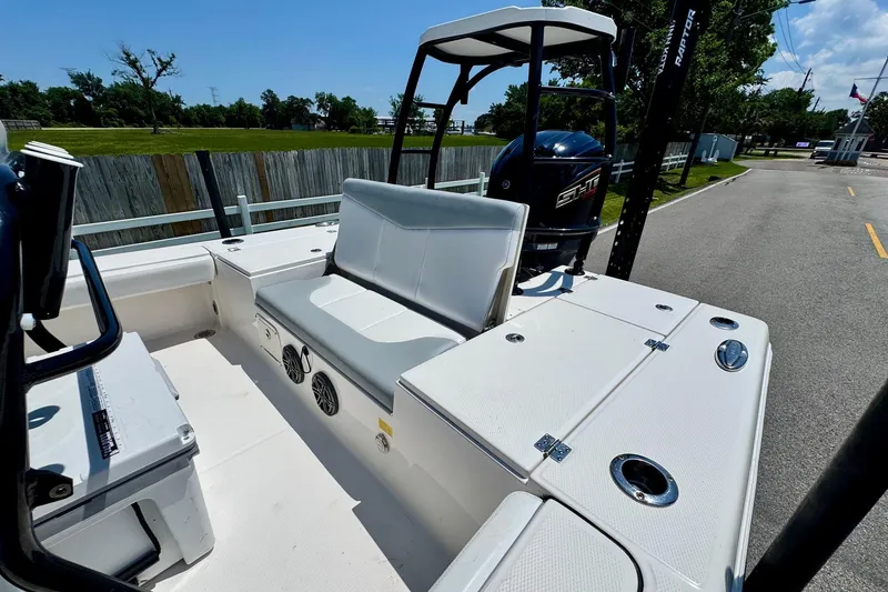 Slide: The Image of 2021 Robalo 246 Cayman boat interior with seating and storage compartments. - 7