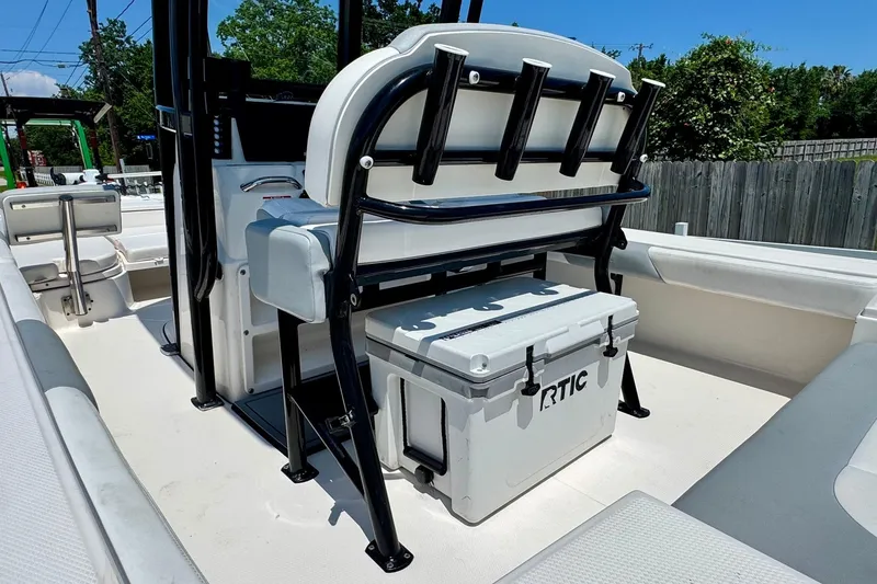 Slide: The Image of 2021 Robalo 246 Cayman boat interior with RTIC cooler and rod holders. - 8