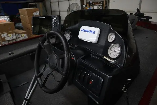 Slide: The Image of Interior view of a 2022 Lowe Skorpion 17 boat with steering console. - 13