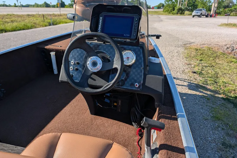 Slide: The Image of 2018 Tracker Bass Tracker 40th Anniversary Heritage Edition boat dashboard with steering wheel and controls. - 14