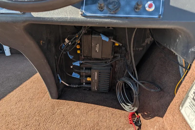 Slide: The Image of 2018 Tracker Bass Tracker boat electronics and wiring under dashboard. - 15