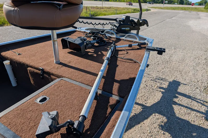 Slide: The Image of 2018 Tracker Bass Tracker 40th Anniversary Heritage Edition boat interior with fishing equipment. - 16